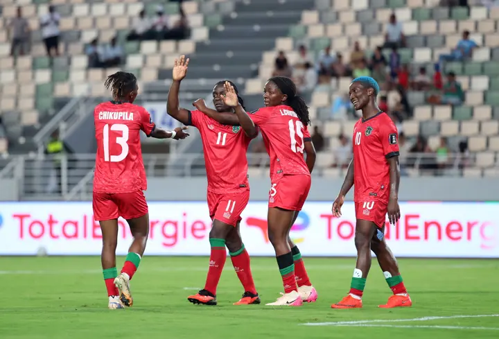 Malawi players celebrating a goal during their WAFCON match against Algeria.