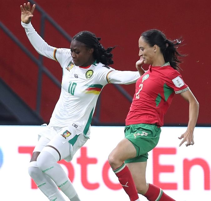 Cameroon players celebrating a penalty shootout victory against Morocco in the WAFCON semi-final.