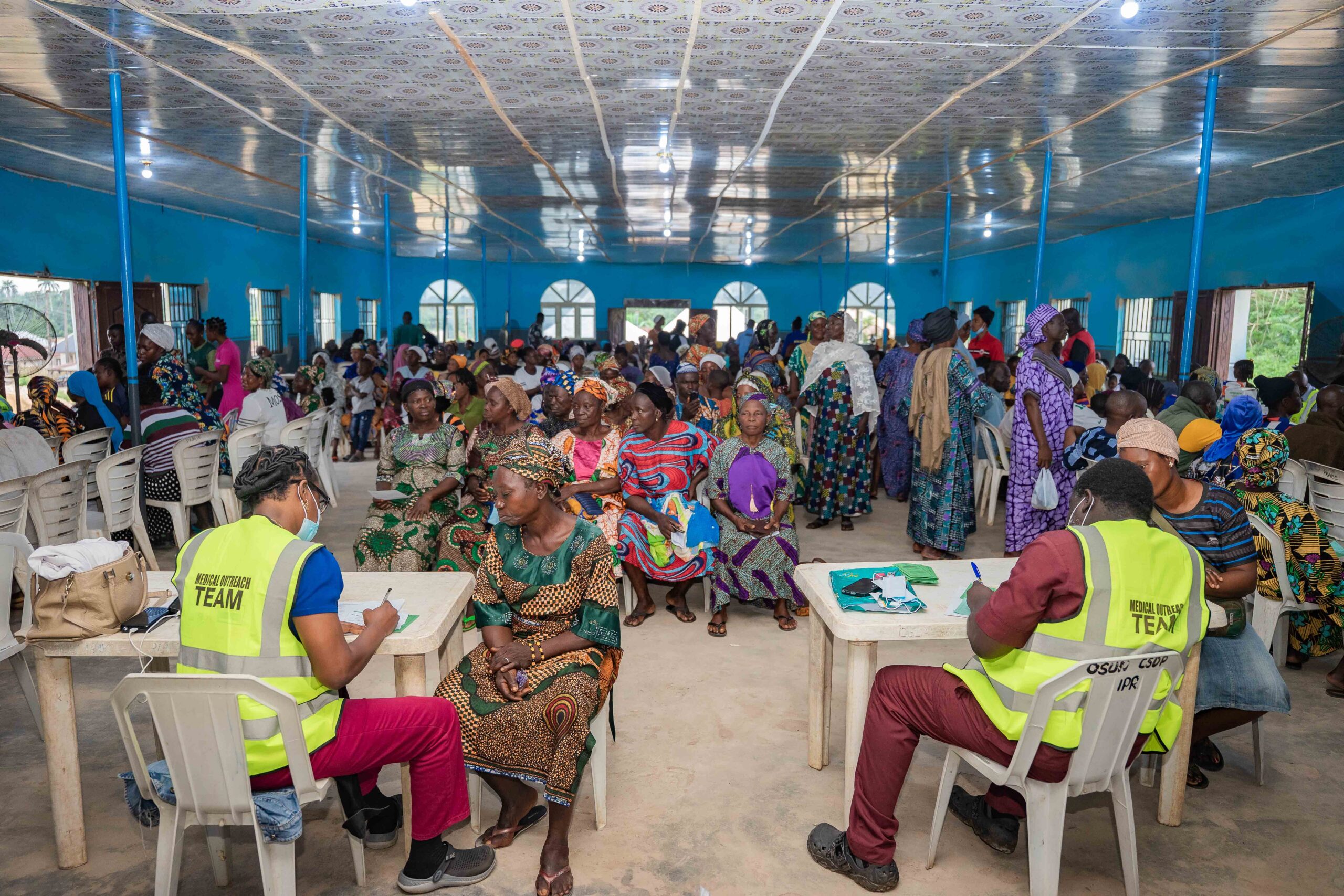 Medical professionals attending to residents during a free healthcare outreach event.